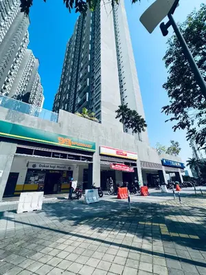 a building with a tall tower in the middle of a street at Kama Homestay @Wangsa Maju in Kuala Lumpur