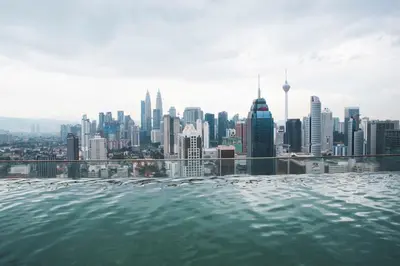 a infinity pool with a view of a city at La Vista @ Regalia Residence in Kuala Lumpur