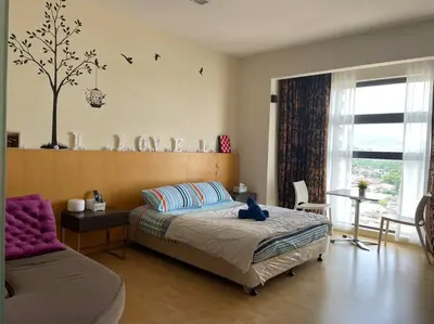 a bedroom with a bed and a tree on the wall at Romantic Suite with Private Jacuzzi 176 in Kuala Lumpur