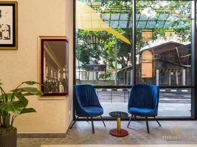 two blue chairs sitting in front of a building at Scarletz Suites Kuala Lumpur, Five Senses in Kuala Lumpur