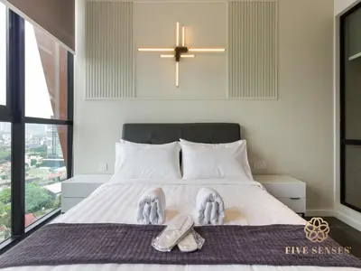 a bedroom with a bed with a pair of shoes on it at Scarletz Suites Kuala Lumpur, Five Senses in Kuala Lumpur