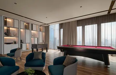 a living room with a pool table at Pan Pacific Serviced Suites Kuala Lumpur in Kuala Lumpur