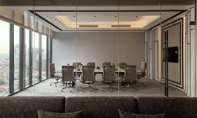 a conference room with a long table and chairs at Pan Pacific Serviced Suites Kuala Lumpur in Kuala Lumpur