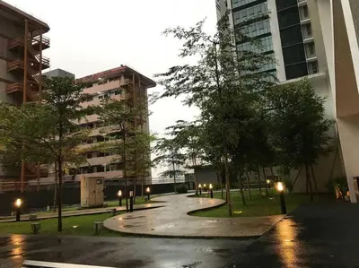 a park with trees and lights in a city at KLCC VIEW-3 BED LOVELY APARTMENTS IN KUALA LUMPUR in Kuala Lumpur