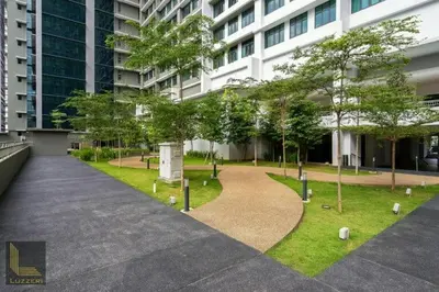 a park in front of a building with trees at KLCC VIEW-3 BED LOVELY APARTMENTS IN KUALA LUMPUR in Kuala Lumpur