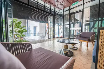 a room with a table and chairs and windows at Scarletz Suites near KLCC by YourSuperhost in Kuala Lumpur