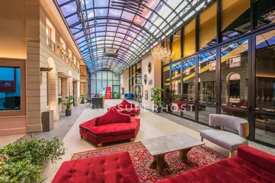 a lobby with a glass ceiling and red furniture at Scarletz Suites near KLCC by YourSuperhost in Kuala Lumpur
