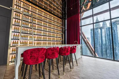 a bar with red chairs in a room with a window at Scarletz Suites near KLCC by YourSuperhost in Kuala Lumpur