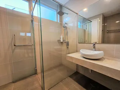 a bathroom with a sink and a glass shower at Bukit Bintang KLCC Binjai 8 Premium Soho Apartment by Sarah's Lodge in Kuala Lumpur