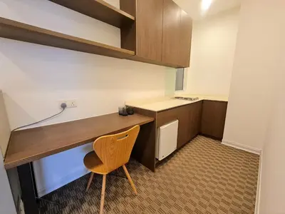 a small kitchen with a wooden desk and a chair at Bukit Bintang KLCC Binjai 8 Premium Soho Apartment by Sarah's Lodge in Kuala Lumpur