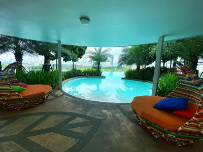 a swimming pool with lounge chairs in a resort at PARC 3 in Cheras, #Sunway Velocity #IKEA #TRX in Kuala Lumpur