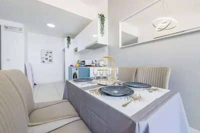 a dining room table with blue plates on it at Cozy Oasis near Ikea TRX Mall King Size Bed 100mb in Kuala Lumpur