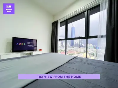 a bedroom with a bed with a tv and a window at Continew Residences TRX Lux Pool View in Kuala Lumpur