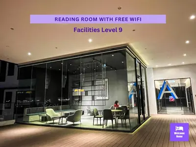 a person sitting at a table in a building at Continew Residences TRX Lux Pool View in Kuala Lumpur