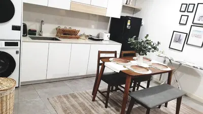 a kitchen with a table and chairs and a sink at Mont Kiara 163 Mall (The Ooak) Private Room in Kuala Lumpur