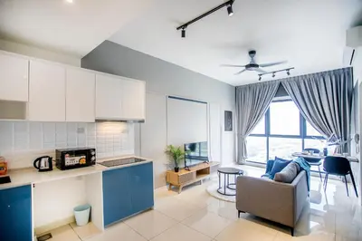 a kitchen and living room with a couch and a table at Continew Residence KL CoBNB in Kuala Lumpur