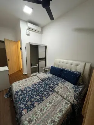 a bedroom with a bed with blue pillows at KLVIEW LEGASI KG BARU in Kuala Lumpur