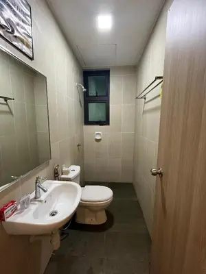 a bathroom with a sink and a toilet and a mirror at KLVIEW LEGASI KG BARU in Kuala Lumpur