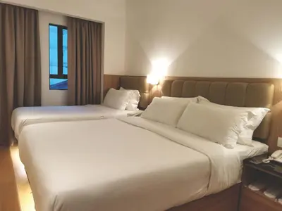 a hotel room with two beds with white pillows at D Loft Hotel in Kuala Lumpur