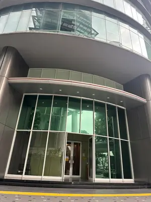 a large glass building with a revolving door at KLCC vortex apartment suites Kuala Lumpur in Kuala Lumpur