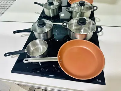 a group of pots and pans on a stove at KLCC vortex apartment suites Kuala Lumpur in Kuala Lumpur