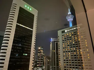 a view of a city at night with the space needle at KLCC vortex apartment suites Kuala Lumpur in Kuala Lumpur