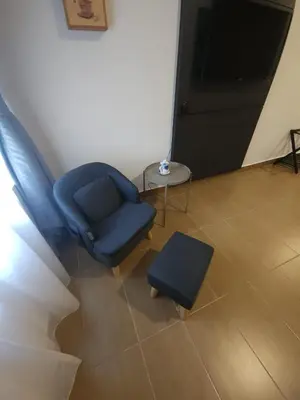 a blue chair and a stool in a room at Yu Hotel Chinatown in Kuala Lumpur