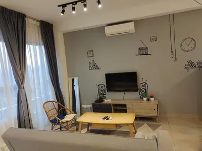a living room with a couch and a tv and a table at Arte plus by Nicestay in Kuala Lumpur
