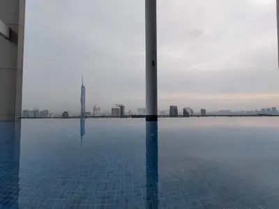 a view of the city from a swimming pool at Colony ( Wisma Infinitum ) in Kuala Lumpur