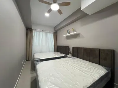 a bedroom with two beds and a ceiling fan at Colony ( Wisma Infinitum ) in Kuala Lumpur