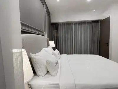 a hotel room with a bed with two white pillows at The Eaton Residences by Times 8 in Kuala Lumpur