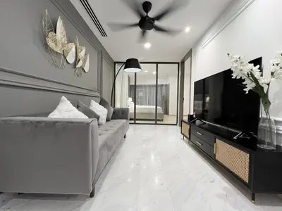 a living room with a couch and a flat screen tv at The Eaton Residences by Times 8 in Kuala Lumpur