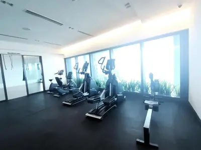 a gym with treadmills and ellipticals in a building at The Eaton Residences by Times 8 in Kuala Lumpur