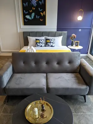 a living room with a couch and a bed at Scarletz Mana-Mana Suites KLCC in Kuala Lumpur