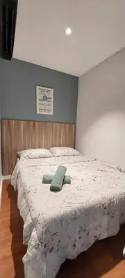 a bedroom with a bed with a green towel on it at Anggun Presidential Suites in Kuala Lumpur