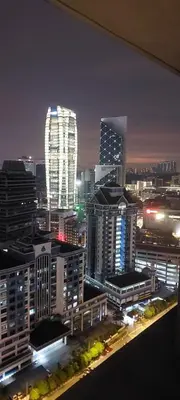 a city skyline at night with tall buildings at Anggun Presidential Suites in Kuala Lumpur