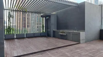an outdoor patio with a sink and a large window at Anggun Presidential Suites in Kuala Lumpur