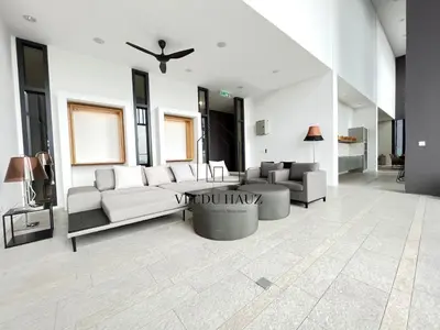 a living room with a couch and a table at Lucentia Residences BBCC at Lalaport Kuala Lumpur by Veedu Hauz in Kuala Lumpur
