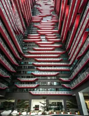 a tall building with many red and white umbrellas at Arte Plus AMPANG by Zzzayn in Batu Empat