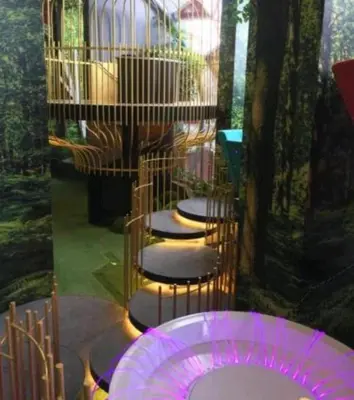 a group of stools in a room with purple lighting at Arte Plus AMPANG by Zzzayn in Batu Empat