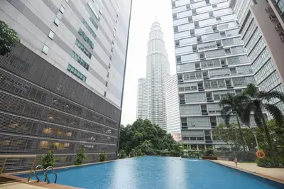 a swimming pool in a city with tall buildings at Central 2BR Apt 5 mins to KLCC Twin Towers in Kuala Lumpur