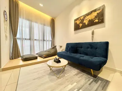a living room with a blue couch and a table at Continew Residence by Shuen in Kuala Lumpur