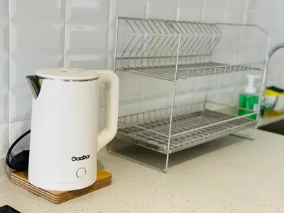 a coffee maker sitting on a counter next to a shelf at Continew Residence by Shuen in Kuala Lumpur