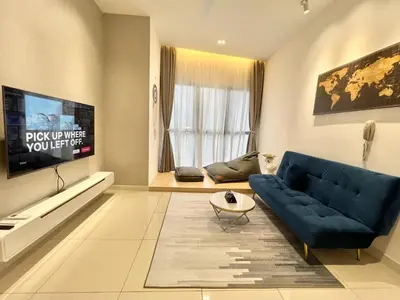 a living room with a blue couch and a tv at Continew Residence by Shuen in Kuala Lumpur