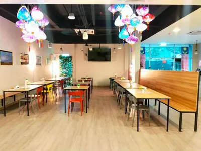 a dining room with tables and chairs and balloons at SCC Velodrome KL in Kuala Lumpur