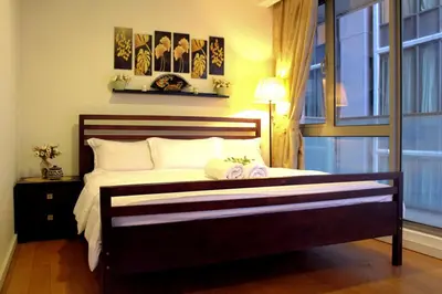 a bedroom with a large bed with a window at D'CASA Fairlane 