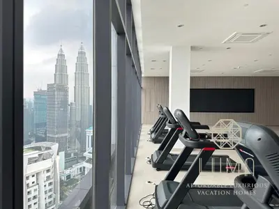 a gym with treadmills and a view of the city at The Platinum 2 Kuala Lumpur by LUMA in Kuala Lumpur