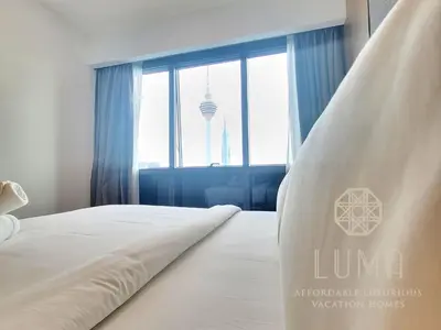 a bedroom with a white bed with a large window at The Platinum 2 Kuala Lumpur by LUMA in Kuala Lumpur