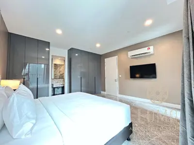 a bedroom with a white bed and a flat screen tv at The Platinum 2 Kuala Lumpur by LUMA in Kuala Lumpur