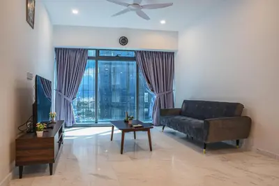 a living room with a couch and a large window at Eaton KLCC Suites By Elite in Kuala Lumpur